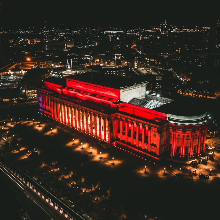 Aerial view of building lit up at night