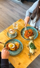 People enjoying food at a table in the Vibe Cafe in Liverpool