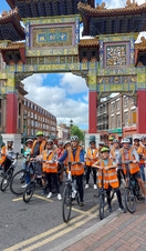 A tour group on bicycles near the Chinese Arch in Liverpool