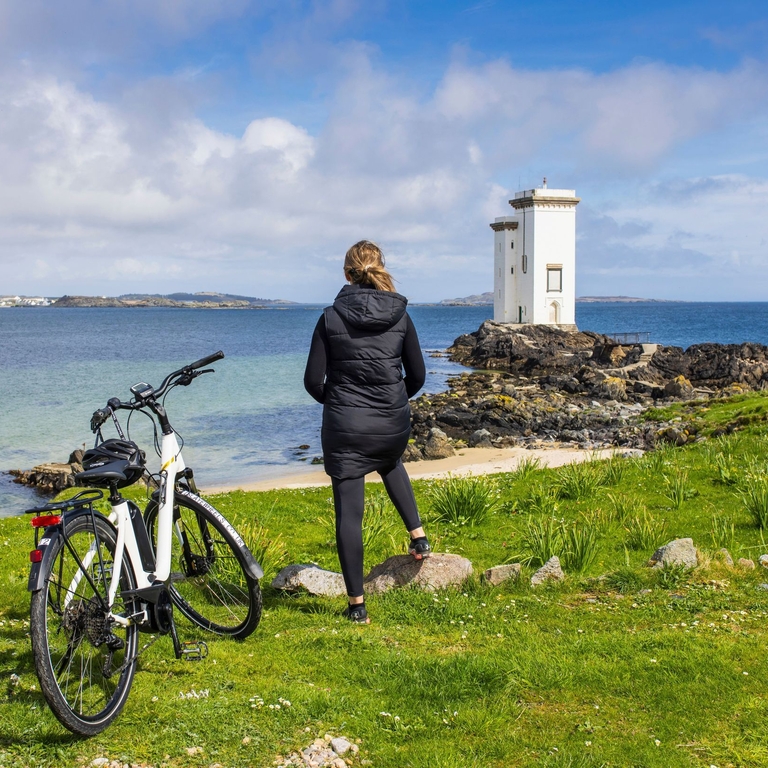 A woman exploring the Isle of Islay via electric bike