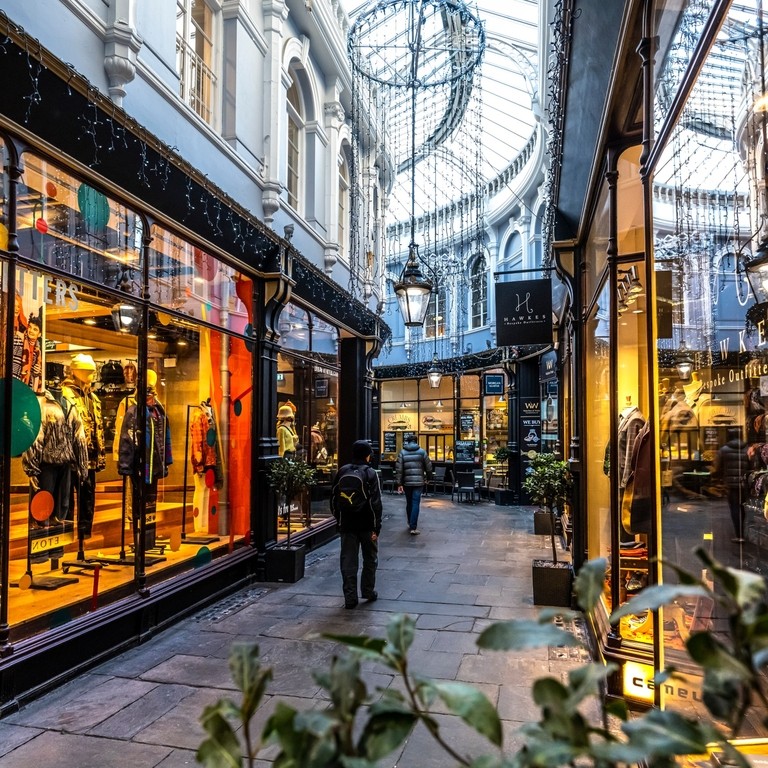 People walking between shops, lit up from inside