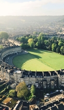 Aerial view of crescent-shaped building surrounded by grass