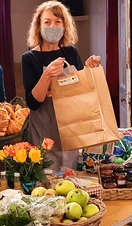 Women serving food at a table in Planet Food, a community cafe and store in York