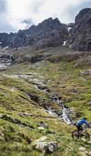 Two mountain bikers cycling downhill down a mountain