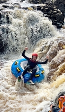 A woman rafting down some rapids at Endless Adventure North East in Newcastle