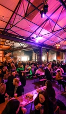 Crowds of people eating and drinking on a night out in the Peddler Market, Sheffield