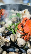 Food collected from coastal foraging cooking on a pan