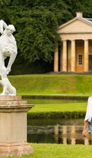 A young couple walking through the grounds of Fountains Abbey and Studley Royal Water Garden, North Yorkshire