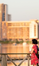 A woman looking out across Cardiff's harbour