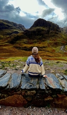A woman sitting in the countryside in autumn.