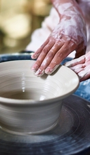 Woman making pottery, Potter's hands making bowl on pottery wheel