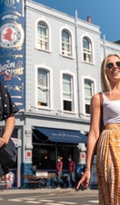 Two women walking along Portobello Road, Notting Hill, London