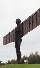 A family group visits the Angel of the North statue near Newcastle upon Tyne.