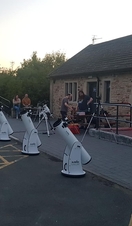 Rows of telescopes being prepared for an evening of stargazing at Grassholme Observatory, Durham