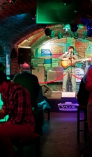 Inside club showing arched ceilings, coloured lights and stage