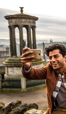A young couple taking a selfie of view over historic town