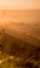 Two men on mountain bikes cycling at Devil's Dyke. Sunrise