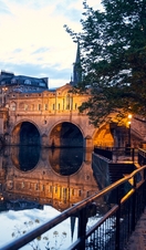 Couple strolling beside a canal in the evening