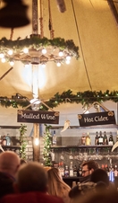Crowd beneath a decorated marquee ceiling