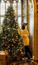 Woman looking at christmas tree decorations