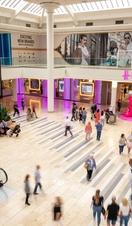 A raised view across Newcastle's Metro Centre with shoppers below