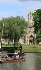 A punting tour passing a historic university building in Cambridge