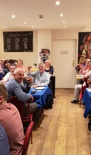 Members of a wine club toasting the camera at Blas ar Fwyd in Snowdonia/Eryri National Park