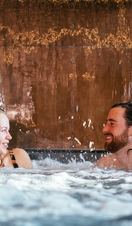 A couple in a pool as part of a spa treatment at Wave Garden Spa