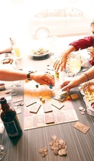 A family playing a board game while eating food at Board Café in Exeter