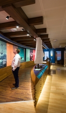 People looking at exhibits inside the Mayflower Museum in Plymouth