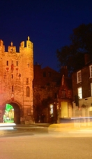 Traffic passing micklegate bar at twilight in york