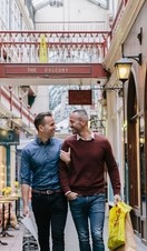 A gay couple enjoying the shopping facilities at Castle Arcade in Cardiff, Wales