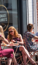 Groups of people sitting outside Handmade Doughnuts in Sheffield