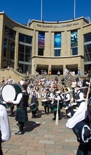 Piping band with drums play for the crowds outside The Glasgow Royal Concert Hall.