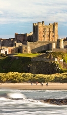 View from a distance of a castle on hill near a beach