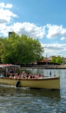 A boat sailing down the river Avon in Stratford-upon-Avon