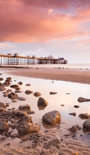 Pier built out into the sea in grand Edwardian style at dusk