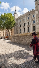 Beefeater walking by the, Tower of London on a sunny day
