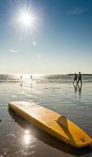 A surfboard in the sun on Borth Beach in Wales