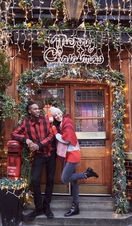 Couple in front of Christmas decorated entrance