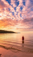 Woman standing in water at Singing Sands beach