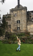 A woman posing in front of Stirling Castle, Scotland