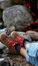 A person in boots, resting and waiting for kettle to boil