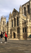 Man twirling a woman outside a historic building