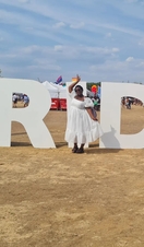 Woman standing in front of Black Pride sign