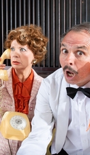 Actors in costume on the set of a farcical play.