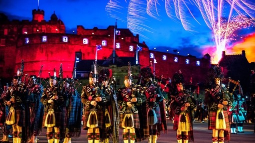 The arena at the Edinburgh Military Tattoo during a performance of the military event, parade ground and packed spectator seating.