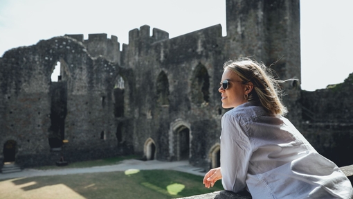 A woman exploring the remains of an old castle.