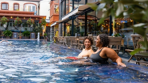 Man and woman relaxing in an outdoor swimming pool