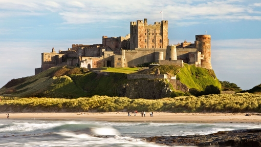 View from a distance of a castle on hill near a beach